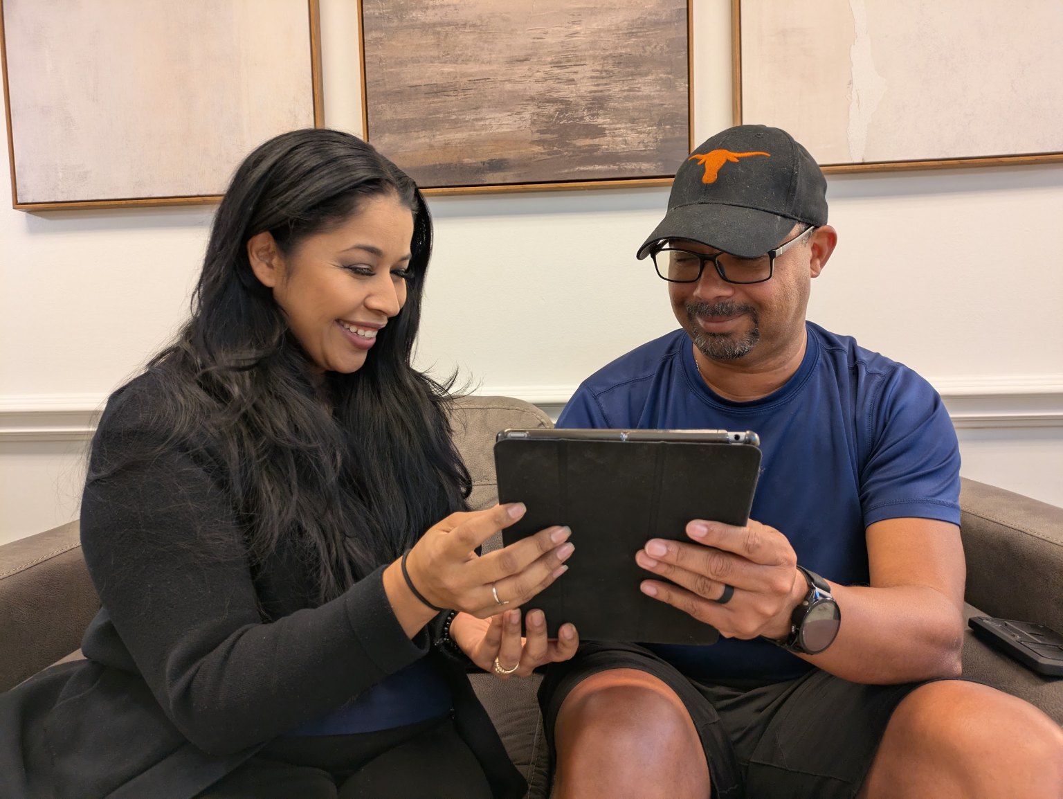 Two patients going through their treatment plan on a tablet in the waiting room